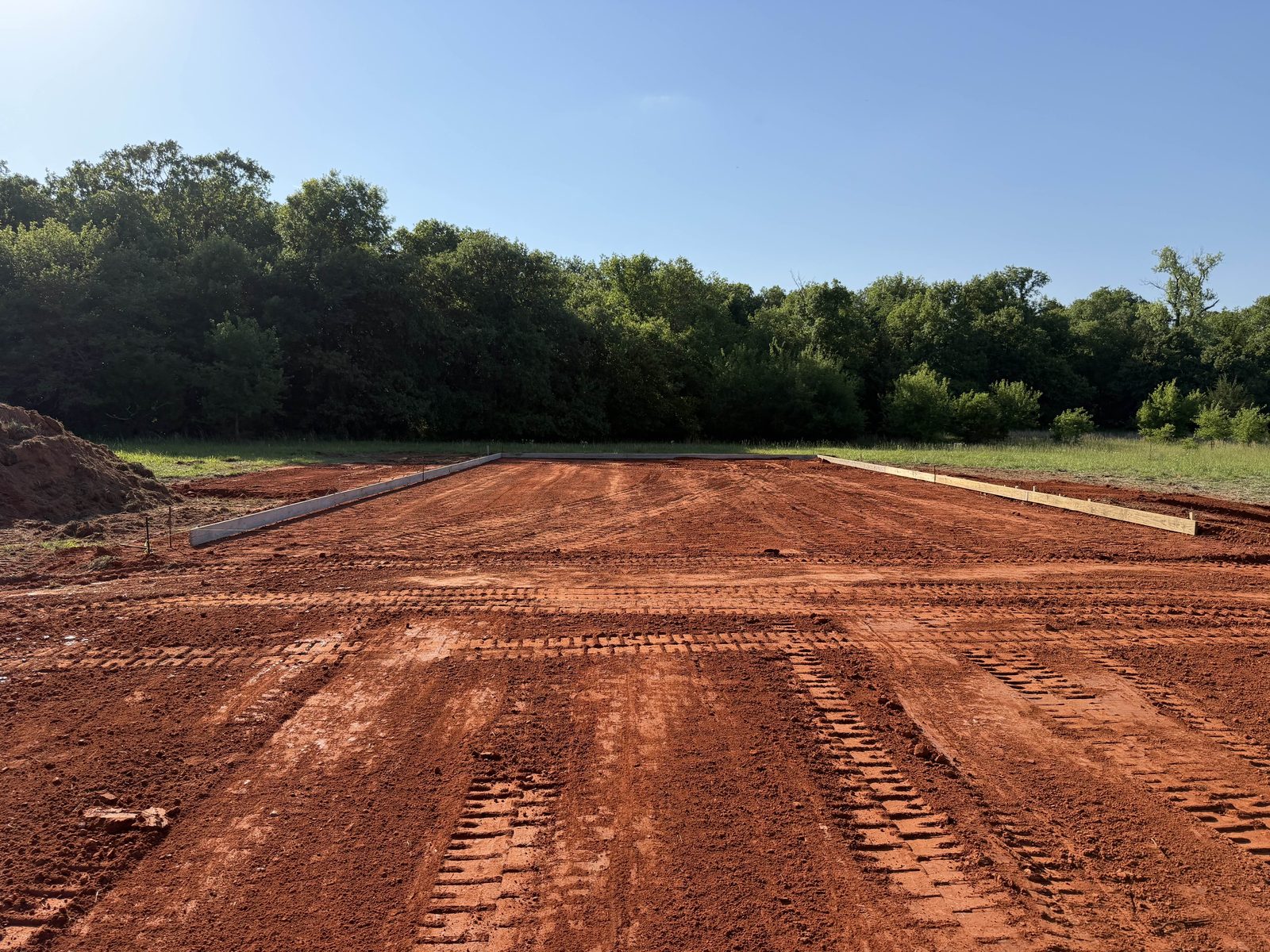 A building pad cut, graded and formed, ready for concrete.