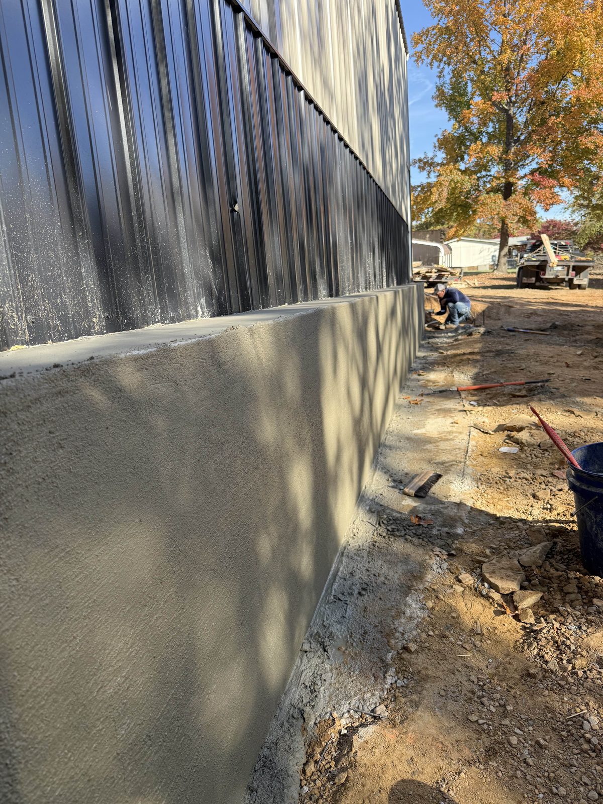 A foundation wall poured against the building line.